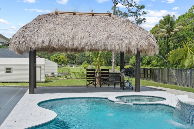 view of swimming pool featuring an in ground hot tub, a grill, a lawn, a bar, and a gazebo