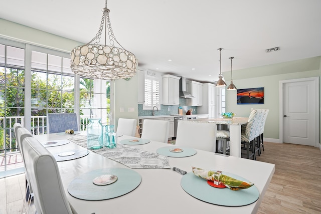 dining room featuring light hardwood / wood-style flooring and sink