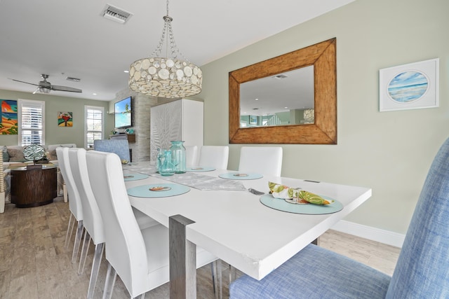 dining room with ceiling fan and light hardwood / wood-style floors