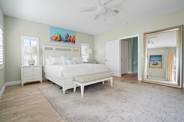 bedroom with ceiling fan and light hardwood / wood-style floors