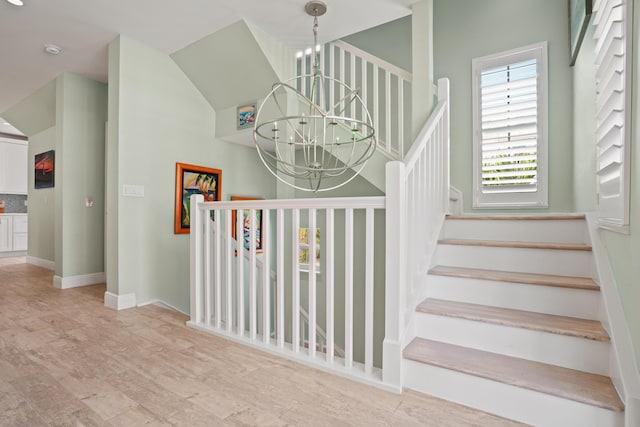 stairway featuring a chandelier and wood-type flooring