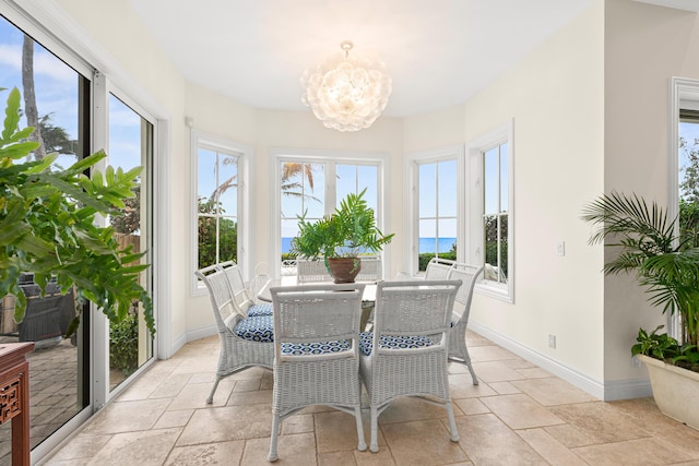 sunroom featuring an inviting chandelier