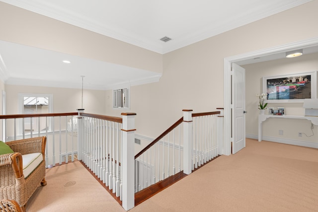 hall with baseboards, carpet flooring, an upstairs landing, and crown molding