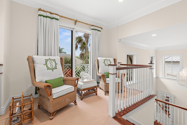 living area with baseboards, carpet, an upstairs landing, and crown molding