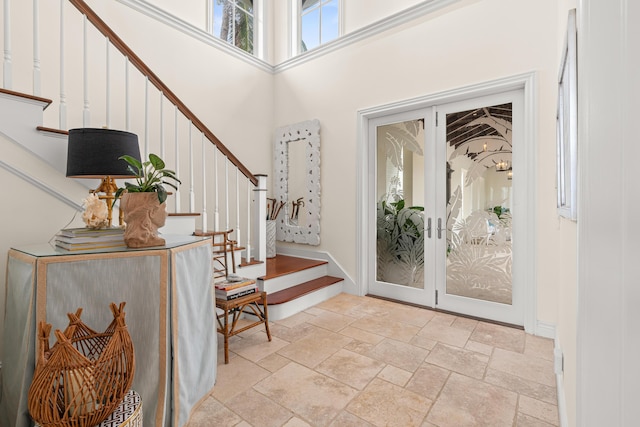 foyer with french doors and a towering ceiling