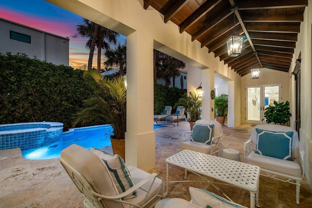 view of patio / terrace with a pool with connected hot tub