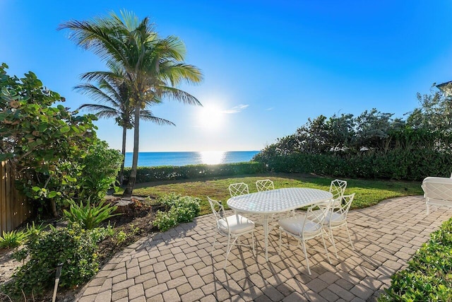 view of patio featuring outdoor dining space and a water view