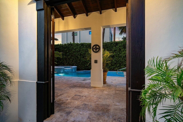 doorway to outside featuring beamed ceiling and wooden ceiling