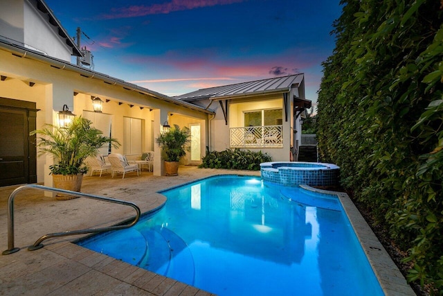 view of swimming pool with a pool with connected hot tub and a patio