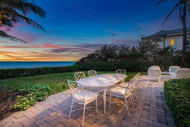 view of patio / terrace with outdoor dining area and a water view