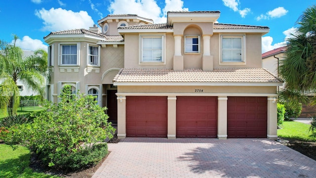 mediterranean / spanish home featuring a garage