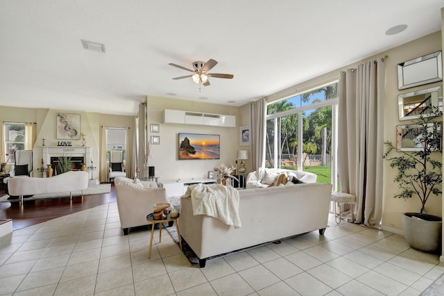 tiled living room featuring ceiling fan