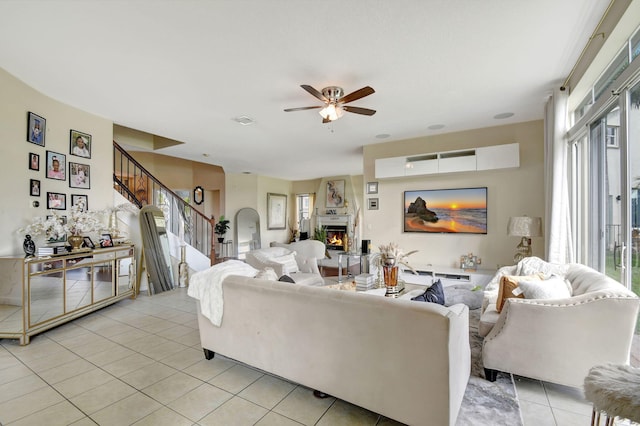 living room with ceiling fan and light tile patterned floors