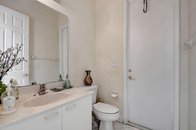 bathroom with toilet, tile patterned floors, and vanity