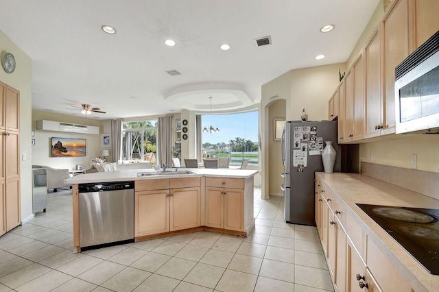 kitchen with appliances with stainless steel finishes, ceiling fan, light tile patterned floors, and light brown cabinets