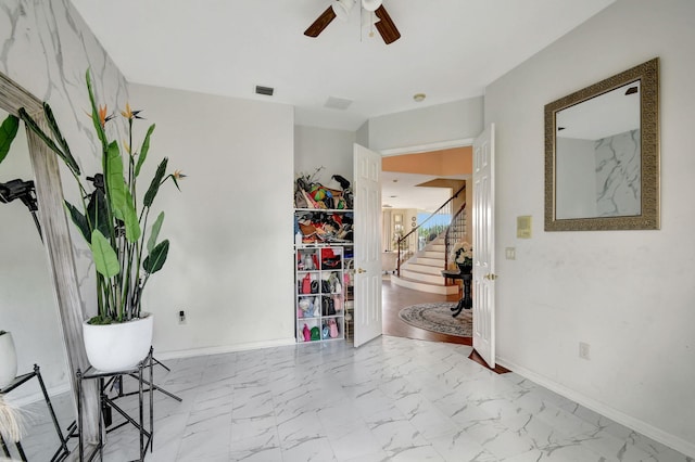 entrance foyer with ceiling fan