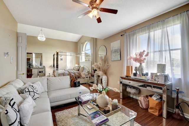 living room featuring ceiling fan, vaulted ceiling, and dark hardwood / wood-style floors