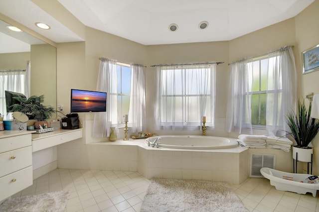 bathroom featuring tile patterned floors, a relaxing tiled tub, and a healthy amount of sunlight