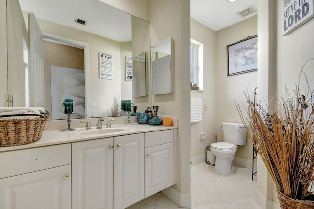 bathroom featuring tile patterned flooring, vanity, and toilet