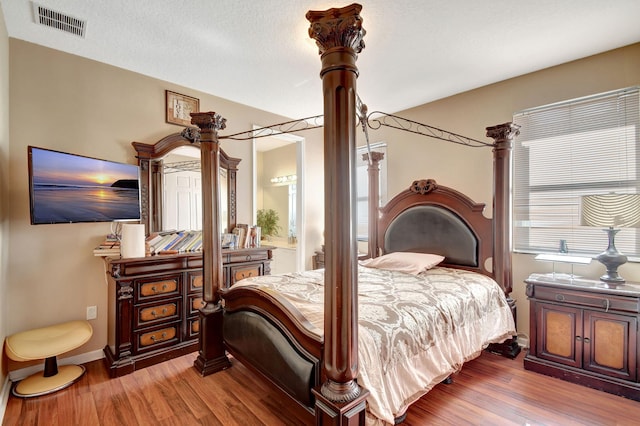 bedroom with hardwood / wood-style floors