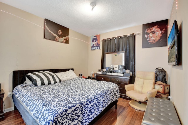 bedroom featuring a textured ceiling and hardwood / wood-style flooring