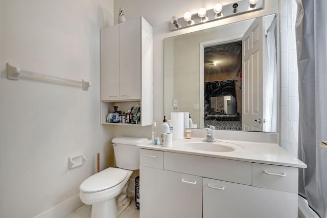 bathroom featuring toilet, vanity, and tile patterned floors