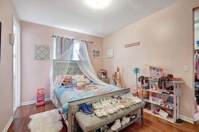 bedroom featuring a textured ceiling and hardwood / wood-style flooring