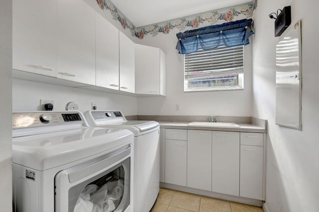 laundry area featuring sink, cabinets, washer and clothes dryer, and light tile patterned floors