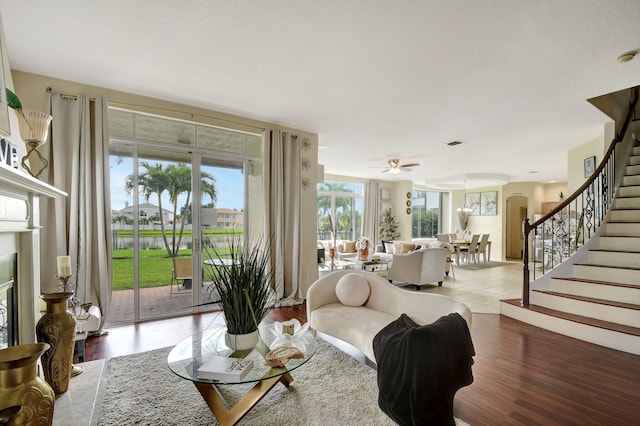 living room with light hardwood / wood-style floors and ceiling fan