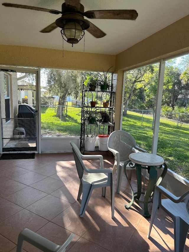 sunroom featuring ceiling fan