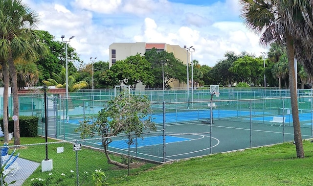 view of sport court with a yard and tennis court