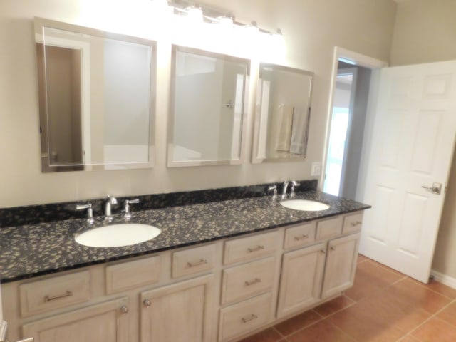 bathroom featuring tile patterned flooring and vanity