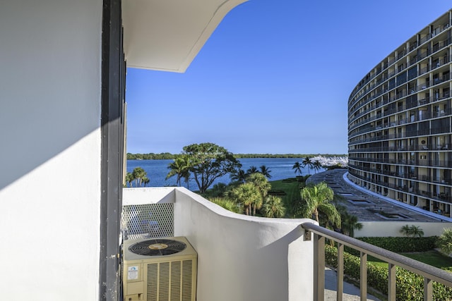 balcony with a water view and central AC unit