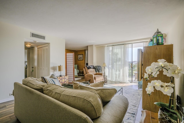 living room featuring wood walls and hardwood / wood-style floors