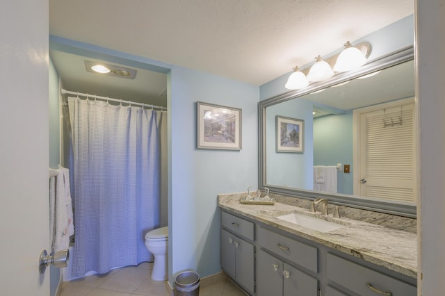 bathroom with curtained shower, toilet, vanity, and tile patterned flooring