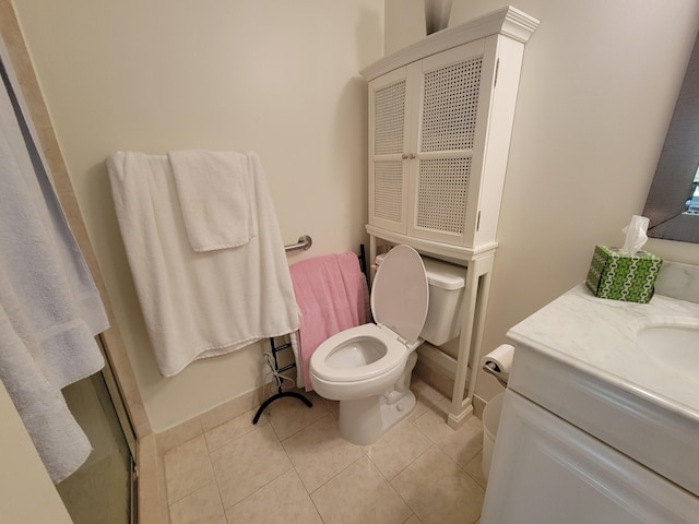 bathroom with toilet, an enclosed shower, vanity, and tile patterned flooring