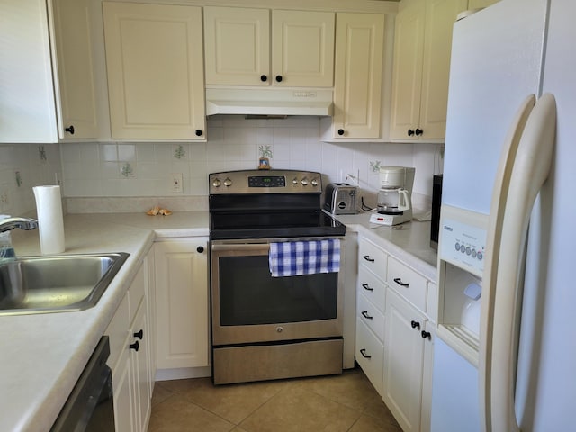 kitchen featuring stainless steel range with electric cooktop, sink, black dishwasher, light tile patterned floors, and white fridge with ice dispenser