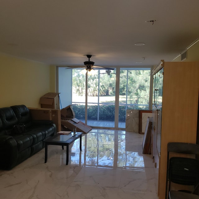 living room with marble finish floor, a wall of windows, and a ceiling fan