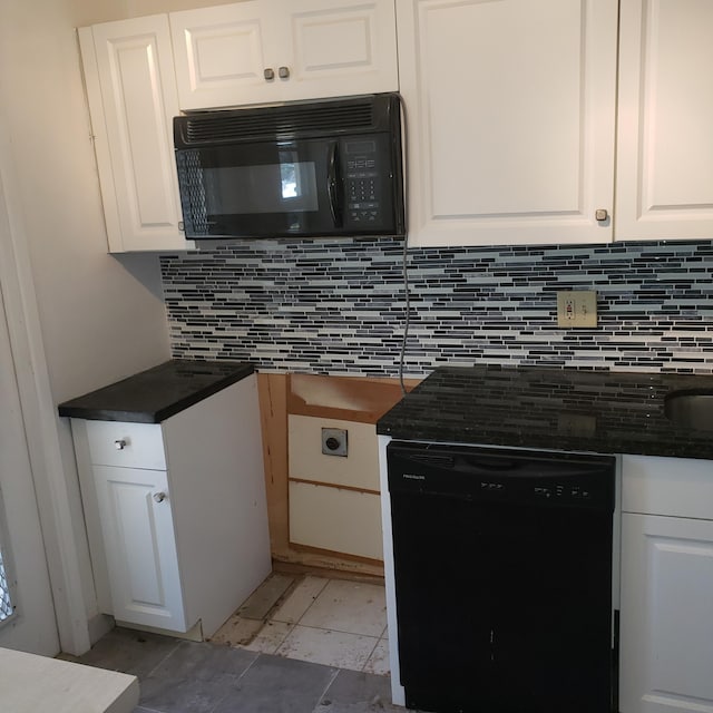 kitchen featuring black appliances, tasteful backsplash, dark countertops, and white cabinetry