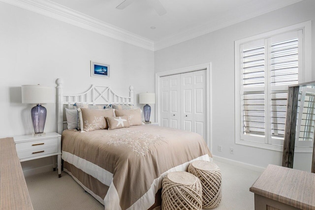 bedroom with ceiling fan, a closet, light carpet, and crown molding