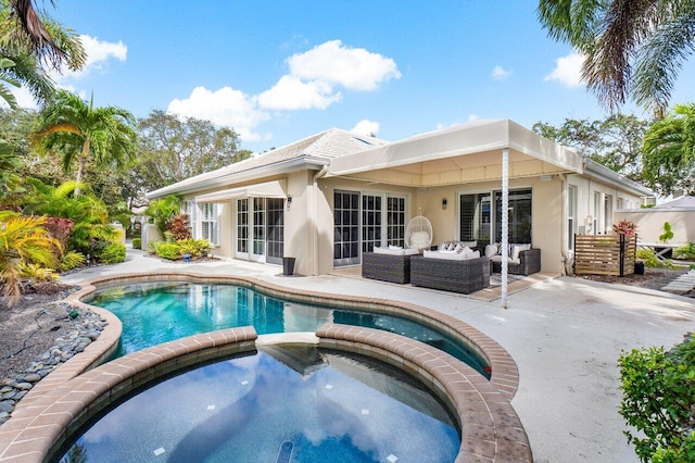 view of pool featuring an outdoor living space, an in ground hot tub, and a patio