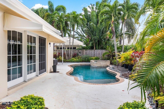 view of pool with an in ground hot tub and a patio