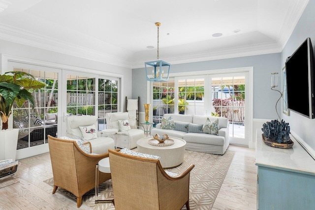 living room featuring light hardwood / wood-style flooring, french doors, and a healthy amount of sunlight