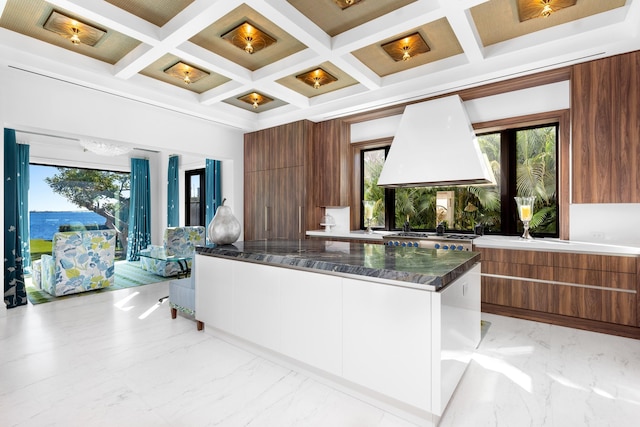 kitchen with custom range hood, modern cabinets, and marble finish floor