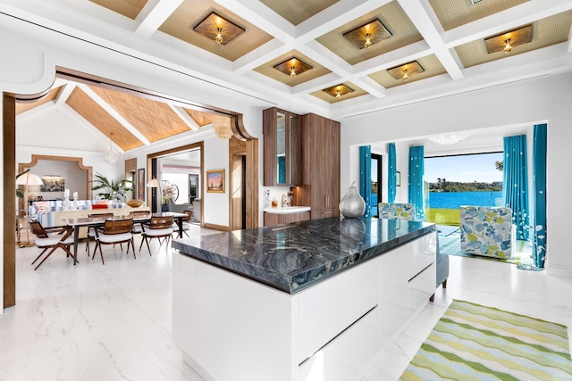 kitchen with marble finish floor, modern cabinets, coffered ceiling, white cabinets, and glass insert cabinets