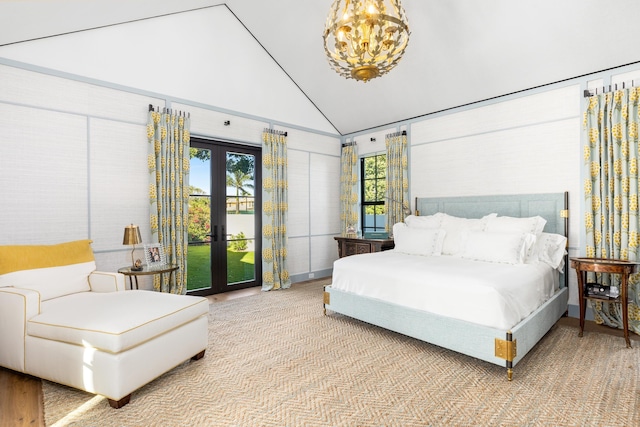 bedroom featuring access to exterior, a chandelier, french doors, and high vaulted ceiling