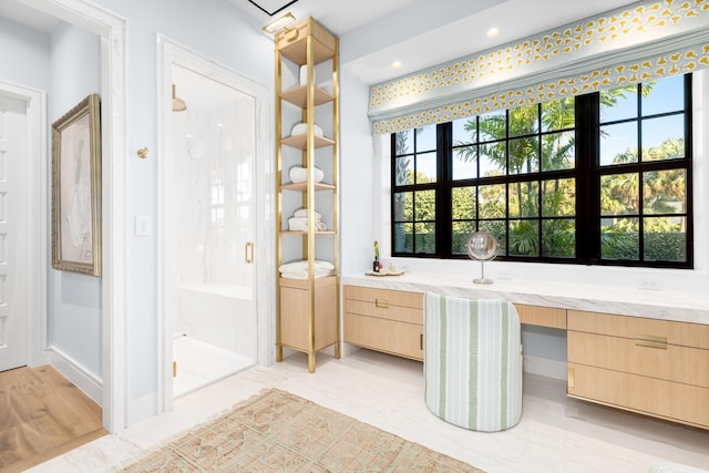 bathroom featuring a stall shower and vanity