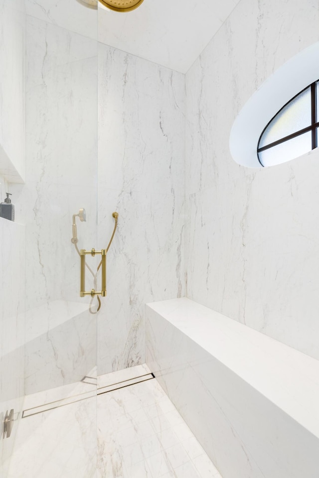 bathroom with a marble finish shower