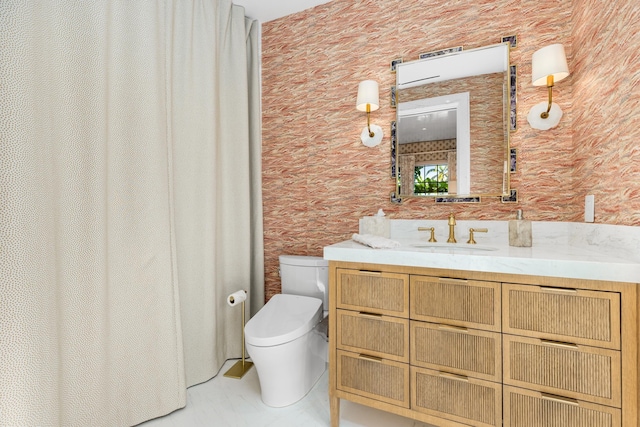 bathroom featuring toilet and vanity