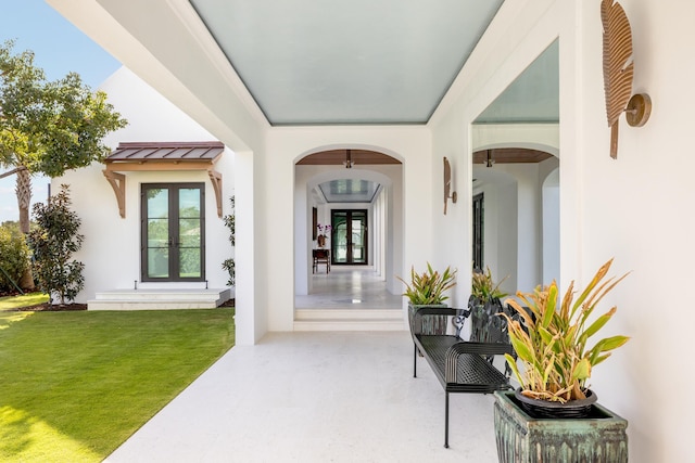 entrance to property with french doors and a yard